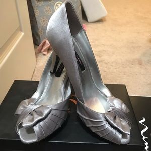 Peep toe silver pumps.